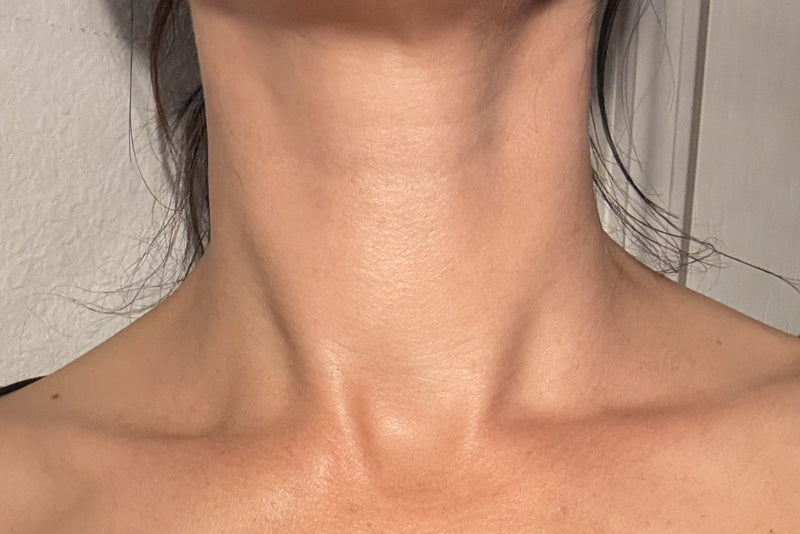 Algae Aura customer applying Algae Aura facial oil down the neck